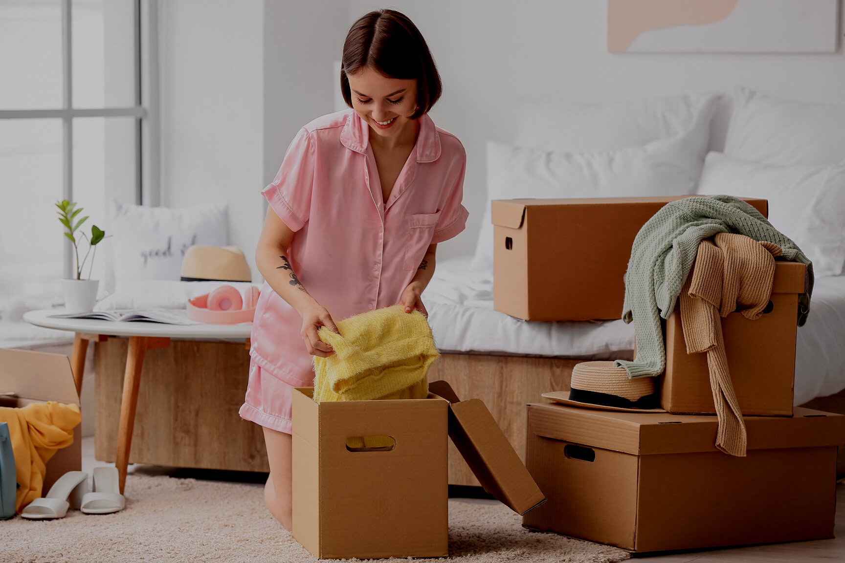 Young Woman Organizing Clothes in Bedroom